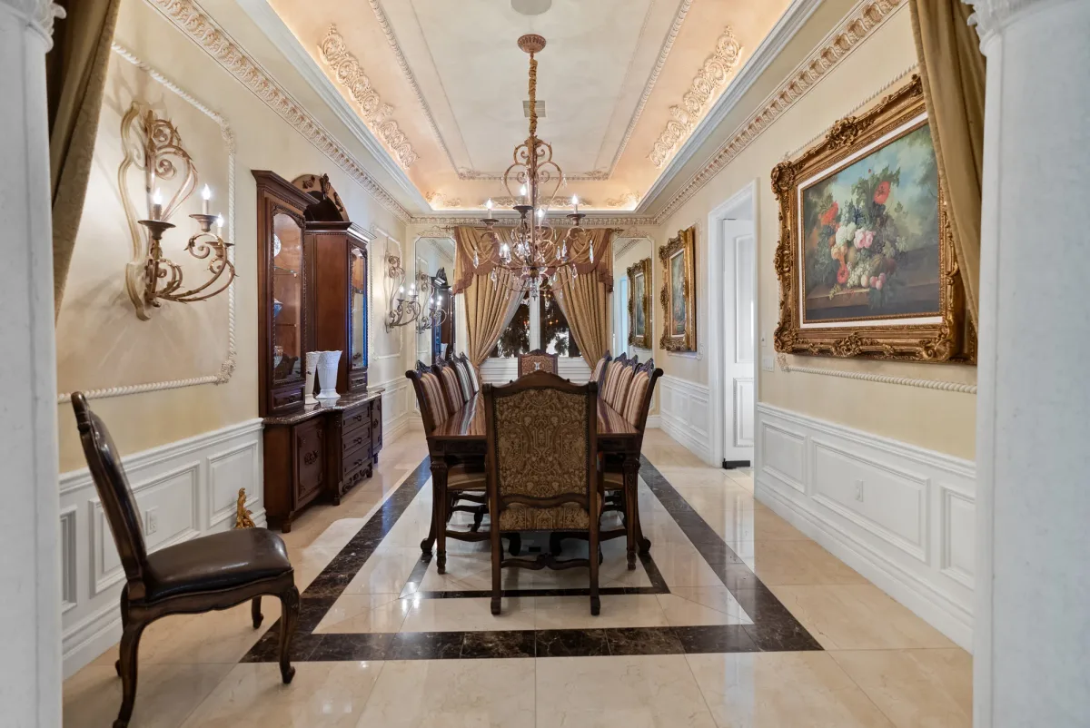 Formal dining room with an ornate chandelier and long wooden table