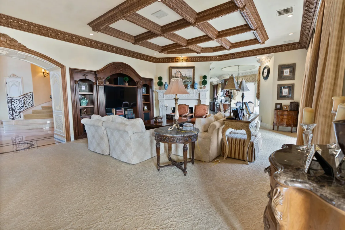 Formal living room with a coffered wooden ceiling and fireplace