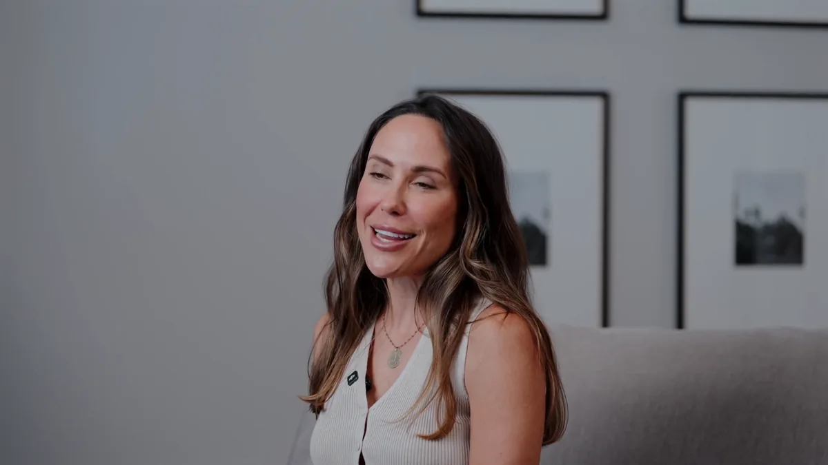 A smiling interview subject in the skincare brand film