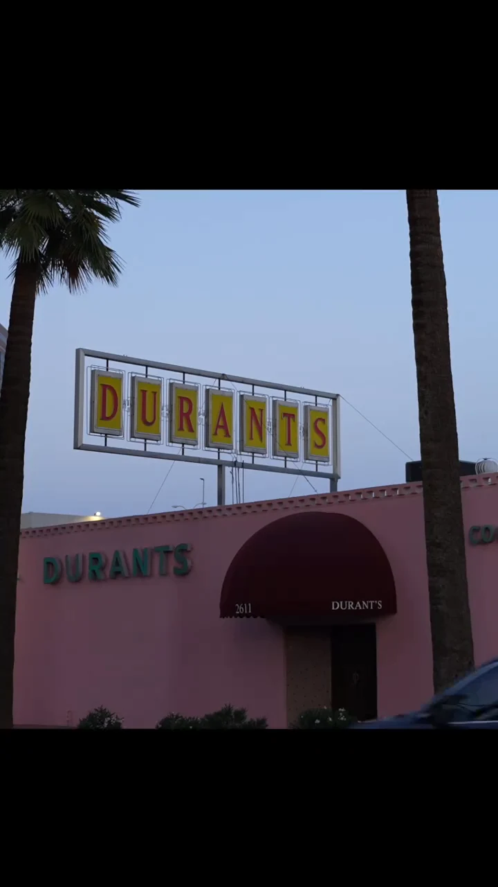 The Durant’s Steakhouse sign and entrance framed by palm trees