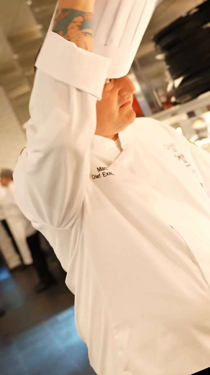A chef preparing food in the Steak 48 kitchen